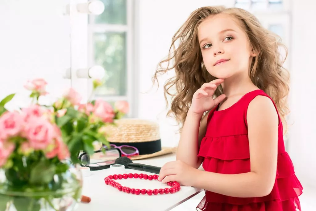 a-little-girl-with-cosmetics-she-is-in-mother-s-bedroom-sitting-near-the-mirror.jpg